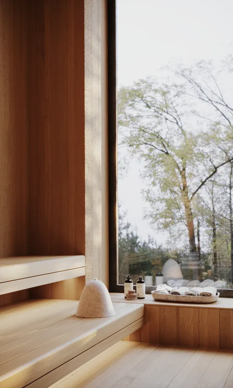 Wood sauna bench by a window onto the trees
